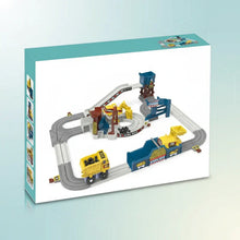 Children’s toy mining truck set with gray tracks, yellow dump truck, and blue and yellow loader structures on white background