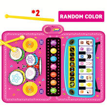 Pink kids electronic drum set and piano toy with yellow drumsticks on white background