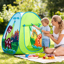 Child and woman playing with colorful dinosaur-themed play tent on grass next to picnic blanket with bowls and fruit