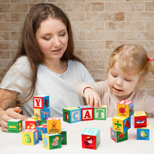 Mother and toddler girl playing with colorful alphabet and picture blocks spelling CAT on white table