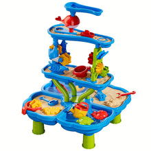 Multilevel blue sand and water play table with red and yellow accessories and green legs on white background