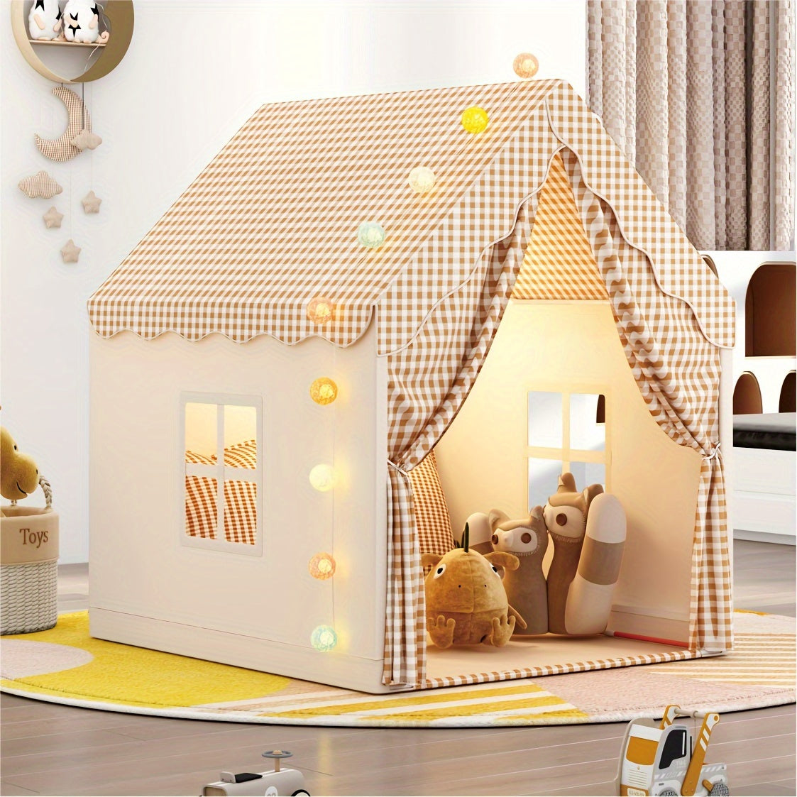 Children's play tent with gingham roof, string lights, and plush animal toys inside on yellow rug in bright room