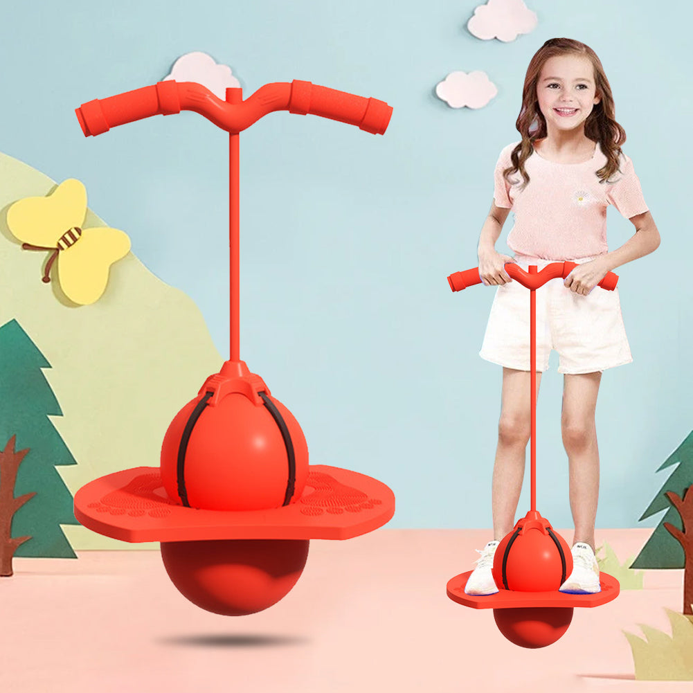 Child holding and balancing on a red spherical pogo jumper toy with handle grips indoors on colorful background