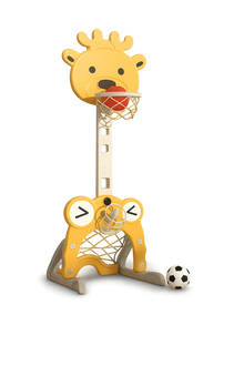 Yellow giraffe-themed children's basketball hoop with red ball in hoop and black and white soccer ball nearby on white background