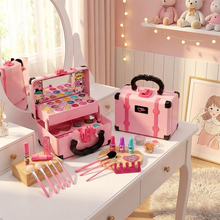 Pink toy makeup vanity set with brushes, nail polish, lipsticks, and a glittery crown on white table in pink room