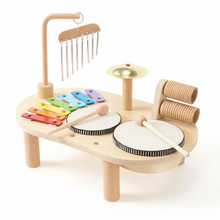 Wooden musical toy set with various instruments on a white background
