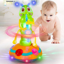 Baby crawling beside colorful bug-shaped musical toy with glowing lights and spinning elements on white floor