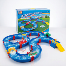 Blue plastic water park toy with winding slides, small figurines, trees, and a yellow slide ramp on white surface