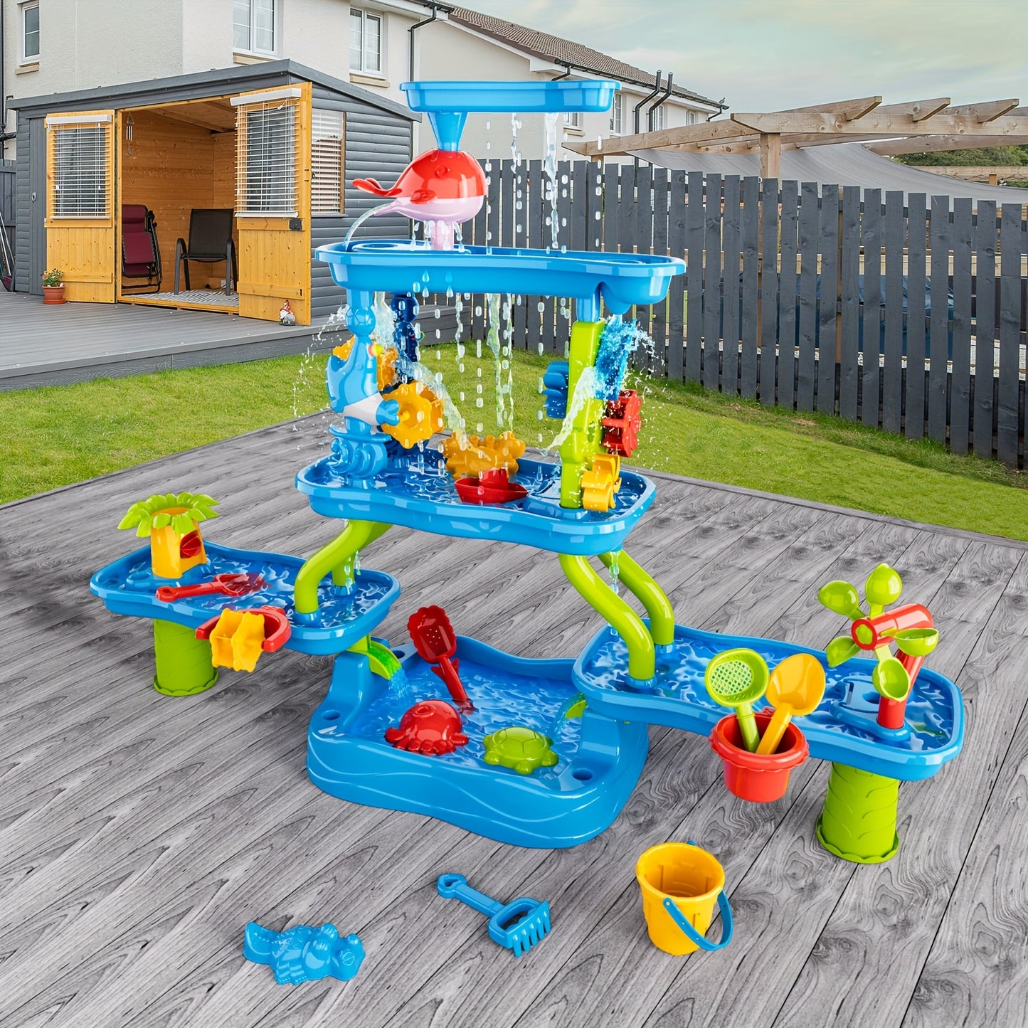 Outdoor blue and green water play table with spinning wheels, funnels, water channels, and colorful accessories on wooden deck