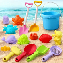 Colorful plastic beach toys including shovels, bucket, sand molds shaped like sea animals and shells on sand near ocean