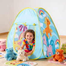 Smiling child playing inside blue play tent decorated with colorful unicorns surrounded by plush teddy bears on floor