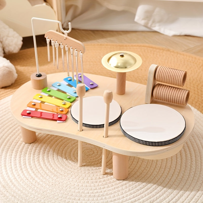 Wooden toddler music set with colorful xylophone, two drums, cymbal, clapper, and mallets on round rug background