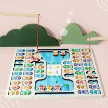 Wooden fishing game with colorful numbered fish pieces and two fishing rods against green cloud shapes on pink background
