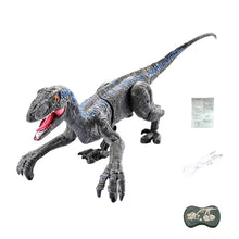 Black and blue articulated dinosaur toy with open mouth, USB charging cable, instruction sheet, and remote control on white background
