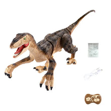 Realistic velociraptor dinosaur toy with open mouth, textured skin, USB cable, instruction sheet, and remote control on white background