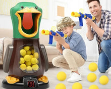 Father and son aiming blue and yellow toy guns at green frog-shaped ball launcher filled with yellow balls indoors