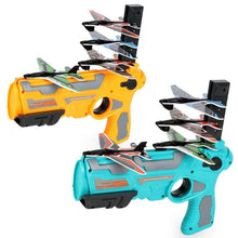 Two toy dart guns in yellow and teal with attached plastic airplane target clips holding small colorful planes