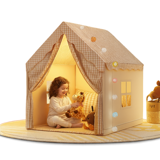 Child playing inside a cozy playhouse with toys on a white background
